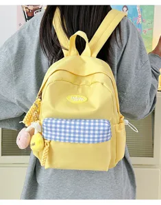 Cute yellow mini backpack for women, canvas school bag with blue plaid pocket and charms.