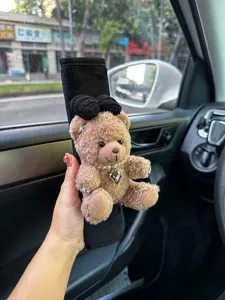 Cute brown teddy bear plush car seatbelt shoulder pad fluffy interior decor accessory.