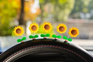 Cute shaking sunflower car ornament detail view, vibrant yellow floral spring dashboard decor