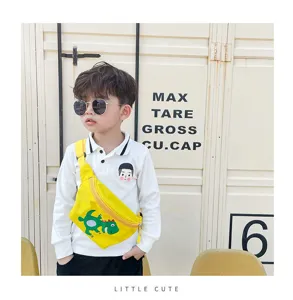 Detail view of the cute children's dinosaur canvas crossbody bag in bright yellow color.