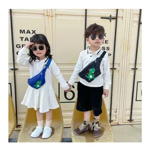 Children's cute dinosaur crossbody waist bag detail shot, showing trendy cartoon design and strap.