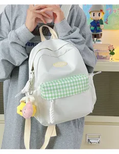 Casual mini backpack for women, cute white rucksack with green plaid front pocket and charm.