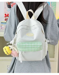 White canvas backpack with green plaid pocket and cute charms, casual mini daypack for women.