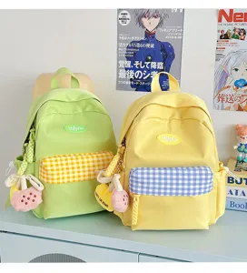 Mini canvas backpack for women, cute school bag with plaid pocket and charms for daily casual use.