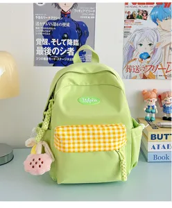 Light green mini backpack for women, cute plaid front pocket design with plush charm for daily.