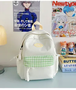 Mini white backpack detail shot with green gingham pocket, aesthetic student book bag.