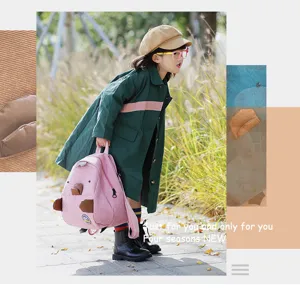 Detail view of the cute pink corduroy mini backpack with playful cartoon animal design for kids.