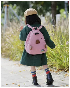 Detailed back view of the cute pink corduroy backpack with playful cartoon animal design features.