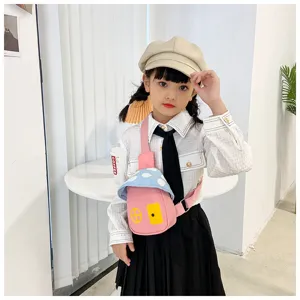 Cute mushroom shaped children crossbody bag detail shot, pink canvas sling bag with blue top.