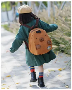 Detailed lifestyle view of the cute corduroy animal backpack showing the lovely patches.