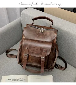 Vintage brown PU leather backpack detail view with top handle and front pocket design.