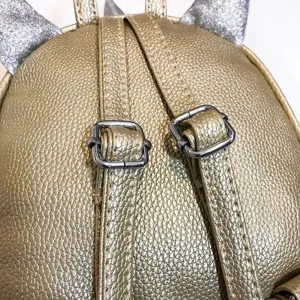 Gold metallic kids mini backpack strap detail, cute glitter unicorn ears style accessory.
