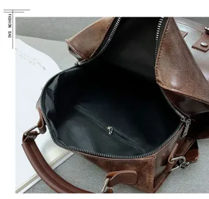 Detail view of vintage brown PU leather backpack interior with spacious main storage.