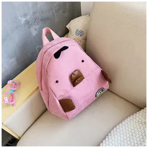 Pink corduroy mini backpack detail, cute cartoon animal design with brown accents, soft daily casual style.