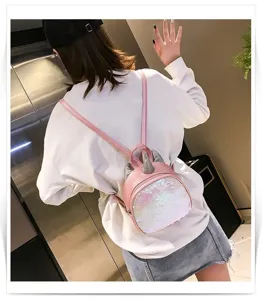 Pink sequin mini backpack detail view featuring cute unicorn horn design and slim straps.