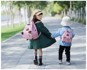 Kids cute animal corduroy mini backpack outdoor detail view showing children wearing pink bags.