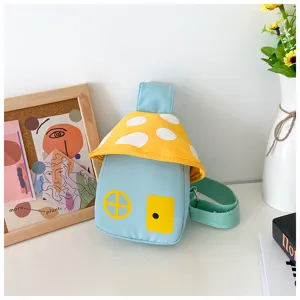 Detail view of the cute mushroom house children crossbody bag with blue body and yellow cap.
