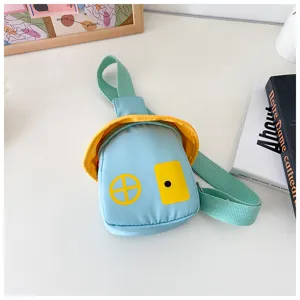 Close-up detail of the cute blue house-shaped children crossbody bag with yellow roof and strap.
