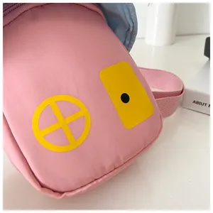 Pink children crossbody bag detail shot, cute house pattern design, portable daily accessory.