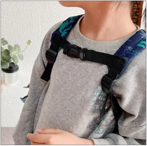 Kids dinosaur backpack detail showing adjustable chest strap and secure buckle design.