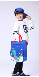 Cute cartoon dinosaur kids tutoring bag detail showing canvas material and side mesh pocket.