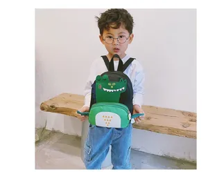 Cute dinosaur toddler backpack detailed view, featuring green cartoon design and comfortable straps.