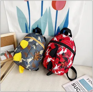 Cute cartoon dinosaur children backpack detail shot showing adorable spine fins and zipper pendant.