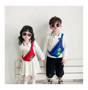 Cute kids dinosaur chest bag detail showing vibrant red and blue crossbody styles for boys and girls.