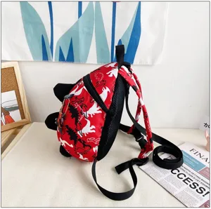 Detail view of cute cartoon dinosaur anti-lost backpack for kids, showing red color and mesh.