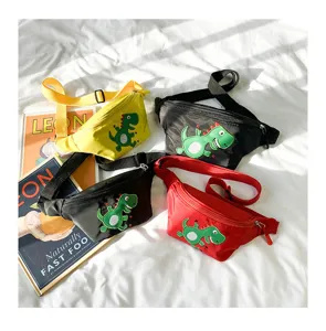 Detail view of cute children waist bags with cartoon dinosaur patch in multi-colors on bed.