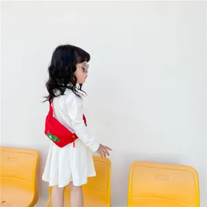 Kids red waist bag with cute cartoon dinosaur patch, trendy casual crossbody bag for babies.