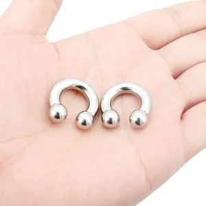 Close-up detail shot of stainless steel horseshoe body piercing circular barbell jewelry.