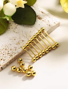 Detailed view of golden 14G 16G stainless steel straight barbell body piercing jewelry.
