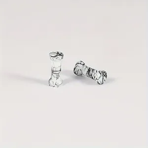 Close-up detail shot of black and white abstract line silicone ear plugs, smooth texture.
