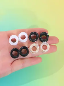 Detail view of 8-piece silicone ear tunnels, flexible ear gauges and stretchers close up.
