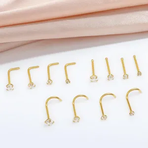Detail view of 12-piece gold nose ring set, stainless steel body piercing studs with crystal.