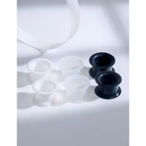 Close-up detail of flexible silicone ear tunnels and plugs stretcher set in black and white colors.