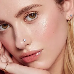 Detailed close-up shot showing a sparkling surgical steel nose stud worn elegantly by a model.