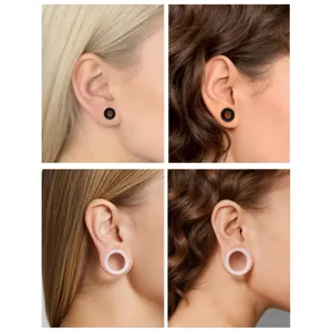 Silicone ear tunnels and gauges detail view, featuring black and pink stretchers for piercing.