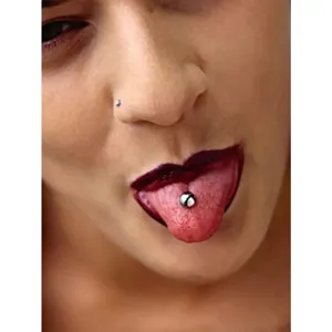 Close-up detail view of stainless steel tongue ring and nose piercing studs, fashion body jewelry.
