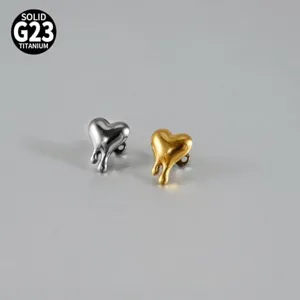 Close-up detail of G23 titanium melting heart micro dermal piercing jewelry studs.
