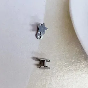 Detail view of G23 titanium five-pointed star micro dermal piercing anchor top jewelry.