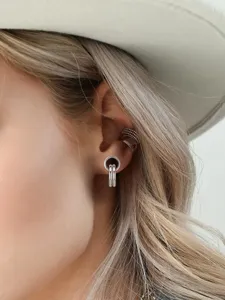 Stainless steel ear tunnel piercing earrings with double ring detail for body modification.