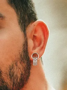 Stainless steel multi ring ear piercing tunnel expander close up men jewelry display.