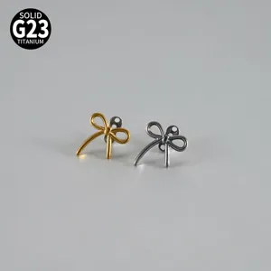 Close-up detail of dual-color titanium bow piercing top, showing refined shape and metal finish.
