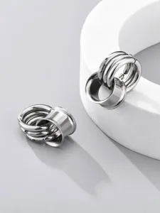 Stainless steel ear gauge tunnels detail shot, showing smooth metallic finish and hoop design.