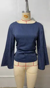 Detail view of women's blue and white striped long bell-sleeve blouse with tie waist design.