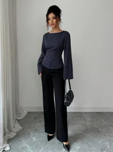 Detail view of the stylish pinstripe long-sleeve blouse with a classic round neckline.