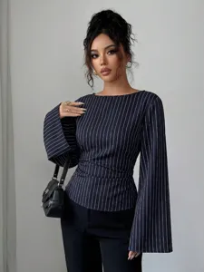 Close-up of the elegant pinstripe long sleeve blouse featuring wide flared cuffs and chic waist.