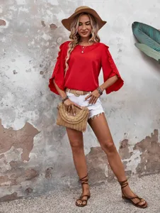 Scene detail shot of the red ruffle sleeve top outfit with straw hat and clutch bag.